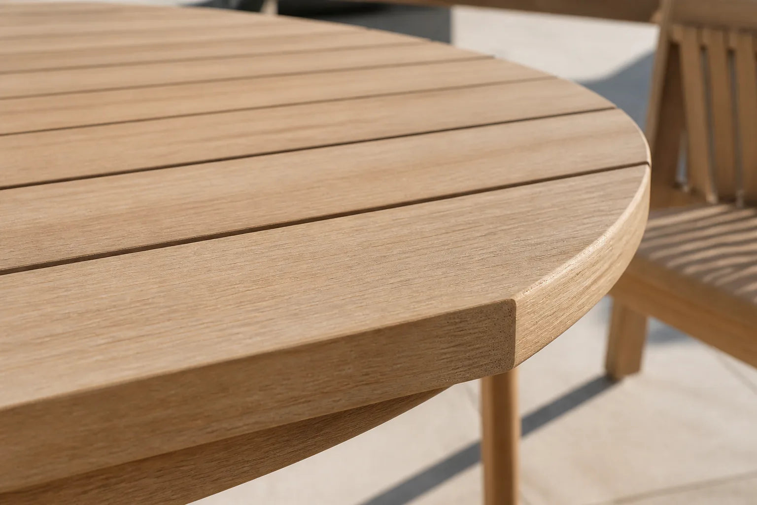 Close detail of a light-teak HIPSWOOD surface and curved furniture construction
