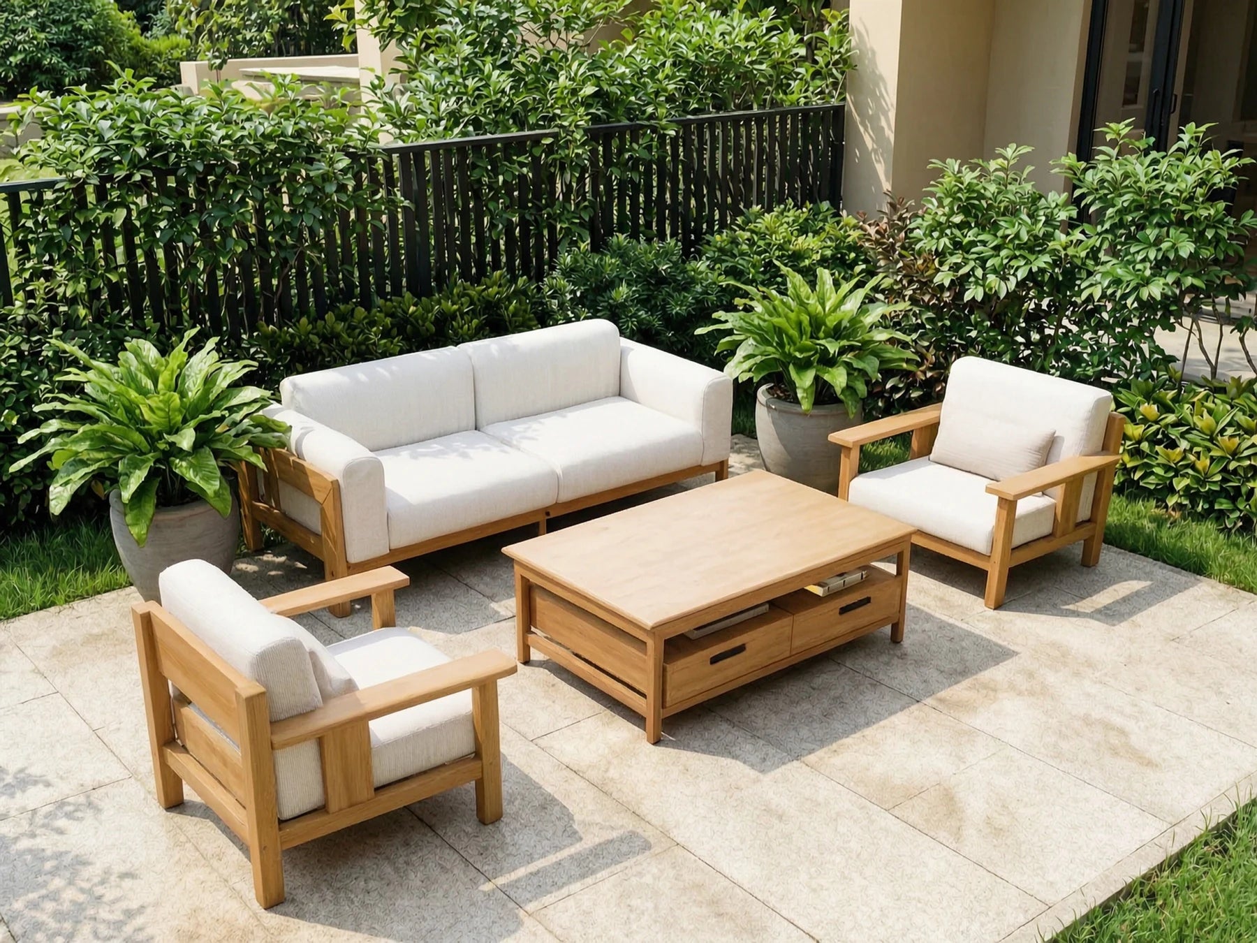 Light teak lounge furniture on a landscaped hospitality terrace